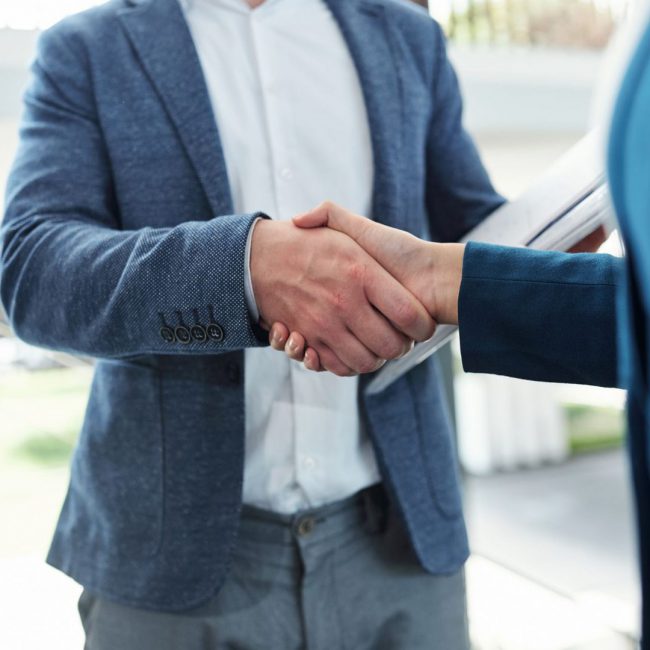 Confirming deal Cropped image of business people shaking hands and confirming deal
