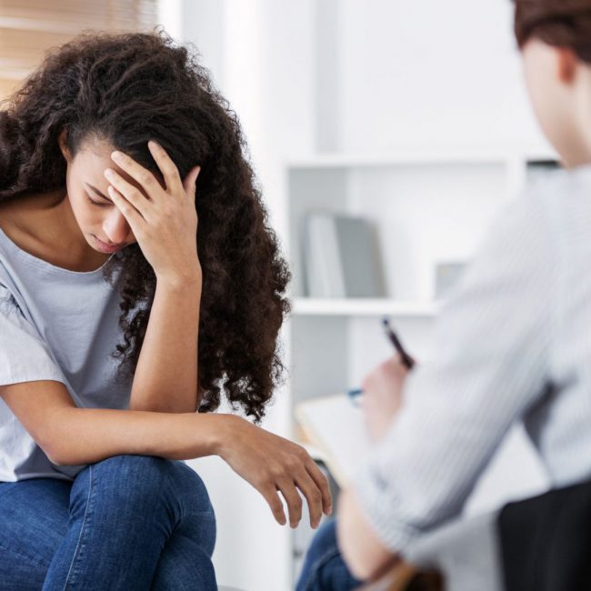 Professional psychotherapies and young woman suffering from ptsd